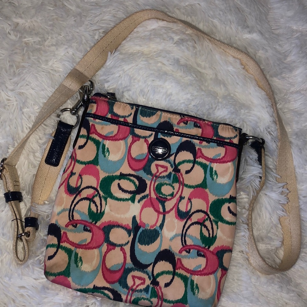 Multicolored coach cross body purse.